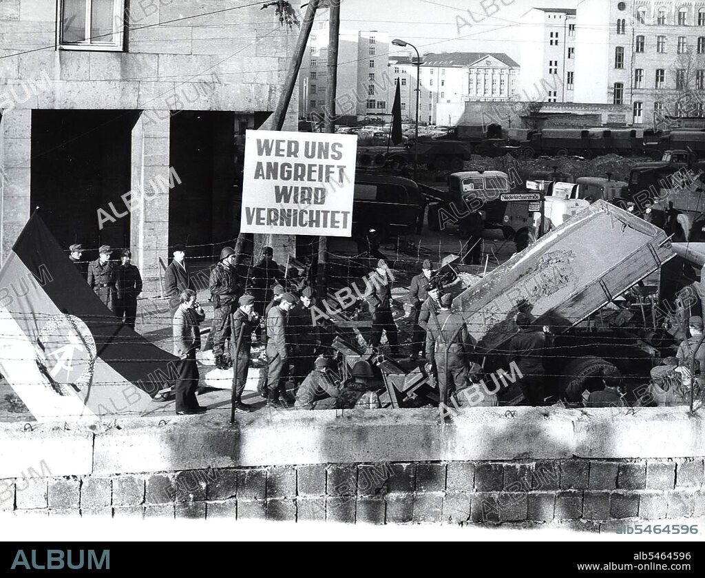 Berlin Wall Photo - 11/20/1961 - Banner Says 'Whoever Attacks Us Will Be Destroyed'. Example of an East German Confrontational Propaganda Banner Produced By the Volksarmee and Volkspolizei.