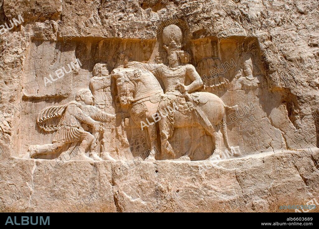 Iran, Provinz Fars, Achämeniden-NekropoleNaqsheRostam: Feslrelief Nr. 6 (Shapur I. unterwirft die römischen Kaiser Valerian und Phillipus Arabs) links unterhalb von Grab III (auch: Grab C) des Perse.