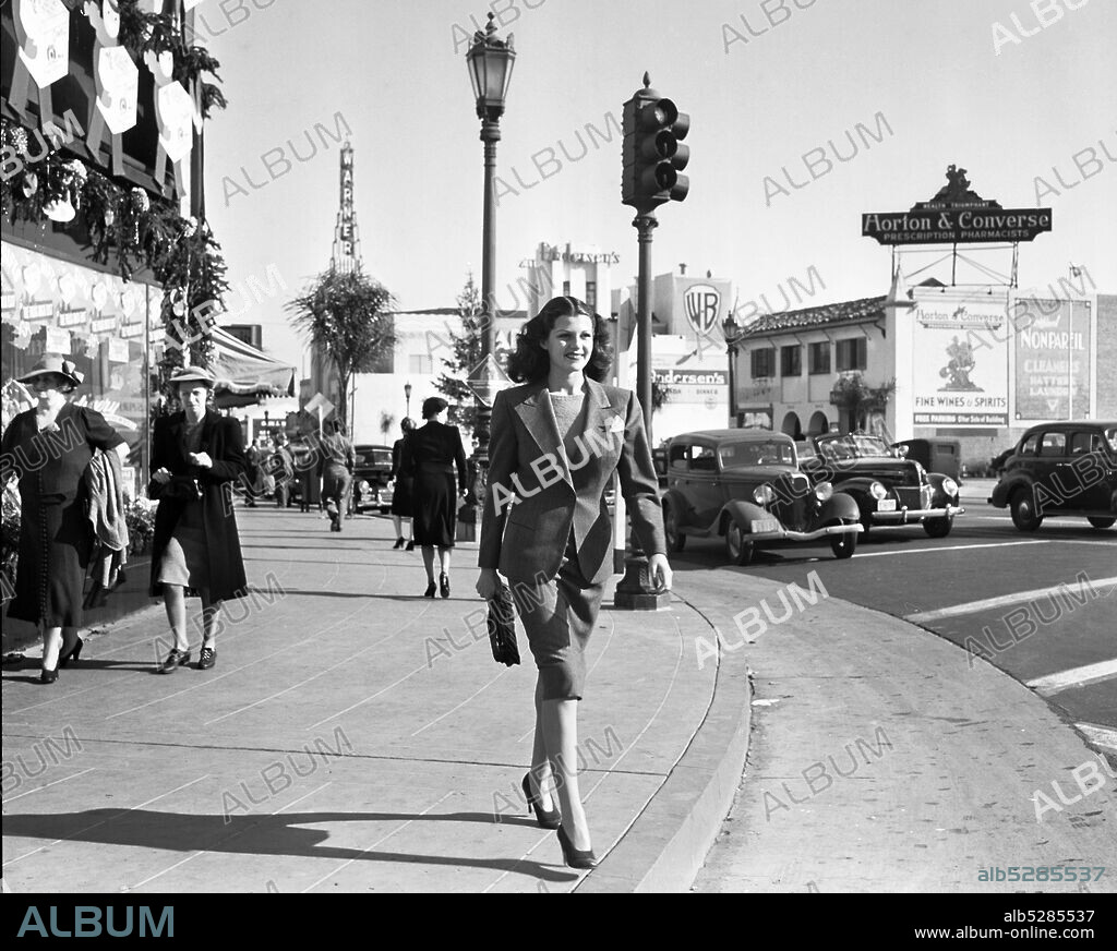 RITA HAYWORTH. January 1, 1940, Los Angeles, California, USA: Young RITA HAYWORTH wearing a suit, enjoys a stroll in pre-war Westwood.