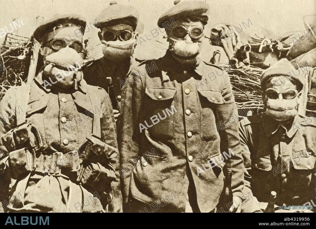 Early gas masks, First World War, 1915, (1935). 'The Introduction of Chemical Warfare: one of the earliest patterns of gas-masks, pads of cotton-wool soaked in a solution of common washing-soda'. From "The Silver Jubilee Book - The Story of 25 Eventful Years in Pictures". [Odhams Press Ltd., London, 1935].