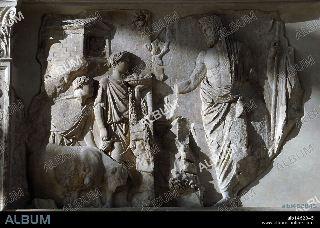 Roman Art. Italy. Ara Pacis Augustae. Aeneas sacrificing to the Penates. Two young attendants in short tunics, with laurel wreaths. The taller one holds a fluted tray in his left hand, filled with fruits and cakes,  and a pitcher in his right hand next to a sacrificial pig. Dated 13th century BC. Museum of the Ara Pacis. Rome. Italy. Rome.